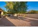 Private backyard with shade trees and a well-maintained gravel landscape, offering a serene outdoor space at 10901 E Sunnydale Dr, Sun Lakes, AZ 85248