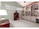 Bedroom with built-in bookshelves, carpet, and bright windows at 10901 E Sunnydale Dr, Sun Lakes, AZ 85248