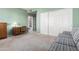 Bedroom featuring a green wall, carpet, and furniture at 10901 E Sunnydale Dr, Sun Lakes, AZ 85248