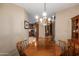 Dining room view with a decorative chandelier and wood furnishings at 10901 E Sunnydale Dr, Sun Lakes, AZ 85248