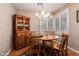 Charming dining room with wood furniture, chandelier, and classic decor at 10901 E Sunnydale Dr, Sun Lakes, AZ 85248