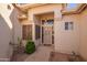 Inviting front porch of the home showcasing a secure screen door and easy-to-maintain desert landscaping at 10901 E Sunnydale Dr, Sun Lakes, AZ 85248