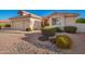 Charming single-story home featuring a terracotta roof and well-maintained desert landscaping, including large river rock at 10901 E Sunnydale Dr, Sun Lakes, AZ 85248