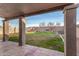 Outdoor back patio area with tile flooring and grassy lawn at 1119 W Heather Ave, Gilbert, AZ 85233