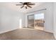 Bright bedroom with a ceiling fan and sliding glass door to a private balcony at 1119 W Heather Ave, Gilbert, AZ 85233