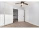 This bedroom has a ceiling fan and a closet for storage at 1119 W Heather Ave, Gilbert, AZ 85233