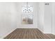 Bright dining room featuring high ceilings, hardwood floors, and a modern chandelier at 1119 W Heather Ave, Gilbert, AZ 85233