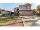 Two-story stucco home showcasing a well-manicured lawn, desert landscaping, and an attached two-car garage at 1119 W Heather Ave, Gilbert, AZ 85233