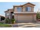 Two-story stucco home showcasing a well-manicured lawn, desert landscaping, and an attached two-car garage at 1119 W Heather Ave, Gilbert, AZ 85233