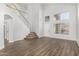 Bright living room featuring high ceilings, hardwood floors, a staircase, and large windows at 1119 W Heather Ave, Gilbert, AZ 85233