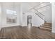 Bright living room featuring high ceilings, hardwood floors, a staircase, and large windows at 1119 W Heather Ave, Gilbert, AZ 85233