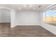 Empty living room with wood floors, a large window, and archway, ready for new homeowners to make their own at 1119 W Heather Ave, Gilbert, AZ 85233