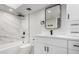 Modern bathroom features a white marble-look tile shower and white vanity with black hardware at 11210 N 109Th St, Scottsdale, AZ 85259