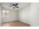 A bright bedroom has a ceiling fan and hardwood floors, freshly painted in neutral colors at 11210 N 109Th St, Scottsdale, AZ 85259