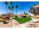 Walkway through common area featuring mature desert landscaping, grassy areas, and community features at 11210 N 109Th St, Scottsdale, AZ 85259