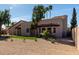 Single-story stucco home with a tile roof, desert landscaping, and mature trees at 11210 N 109Th St, Scottsdale, AZ 85259