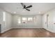 Sun-filled living room with hardwood flooring, contemporary ceiling fan, and generous windows offering bright natural light at 11210 N 109Th St, Scottsdale, AZ 85259