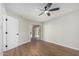 Charming bedroom featuring ceiling fan, hardwood floors, slider, and ample closet space for comfort and convenience at 11210 N 109Th St, Scottsdale, AZ 85259