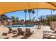 This resort style pool features lounge chairs, seating, mature desert landscaping, and room to relax at 11210 N 109Th St, Scottsdale, AZ 85259