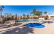 This community pool has a spa, ramada, seating, lounge chairs, and mature desert landscaping at 11210 N 109Th St, Scottsdale, AZ 85259