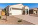 Inviting single-story home with a desert landscape, paver driveway, and a two-car garage at 11620 W Marguerite Ave, Avondale, AZ 85323