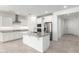 Modern kitchen featuring white cabinetry, stainless steel appliances, a large island, and sleek countertops at 11620 W Marguerite Ave, Avondale, AZ 85323