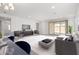 Spacious living room featuring a large window, contemporary furnishings, and plenty of natural light at 11620 W Marguerite Ave, Avondale, AZ 85323