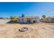 Spacious backyard with fire pit, offering a great outdoor space perfect for entertaining and relaxing at 12010 N 113Th Ave, Youngtown, AZ 85363