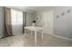 Bright dining area with wood-look floors, decorative accents, and lots of natural light at 12010 N 113Th Ave, Youngtown, AZ 85363