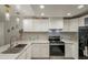 Stylish kitchen with stainless steel appliances, white cabinetry, and modern fixtures offering a sleek design for cooking at 12010 N 113Th Ave, Youngtown, AZ 85363