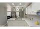 Bright and airy kitchen with white countertops, pendant lights, and stainless steel sink offering a modern cooking space at 12010 N 113Th Ave, Youngtown, AZ 85363