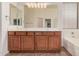 Bathroom with double sink vanity, tile floors, and lots of lighting at 12622 W Apodaca Dr, Litchfield Park, AZ 85340