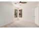 Bedroom features dual windows for natural light and neutral carpet; ceiling fan present at 12622 W Apodaca Dr, Litchfield Park, AZ 85340