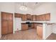 Spacious kitchen featuring wood cabinets, stone countertops, and tile flooring at 12622 W Apodaca Dr, Litchfield Park, AZ 85340