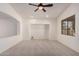 Bright and airy living room with neutral carpet, featuring an open layout and ample natural light at 12622 W Apodaca Dr, Litchfield Park, AZ 85340