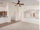 Bright living room featuring a ceiling fan, neutral paint, and seamless flow to the kitchen at 12622 W Apodaca Dr, Litchfield Park, AZ 85340