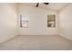 Spacious main bedroom featuring a ceiling fan, and two large windows at 12622 W Apodaca Dr, Litchfield Park, AZ 85340