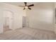 Spacious main bedroom featuring a ceiling fan, neutral paint, and ensuite bathroom at 12622 W Apodaca Dr, Litchfield Park, AZ 85340