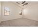 Spacious main bedroom featuring a ceiling fan, and two large windows at 12622 W Apodaca Dr, Litchfield Park, AZ 85340