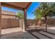 Outdoor patio featuring concrete flooring, rock landscaping, a gate, and a tropical palm tree at 12622 W Apodaca Dr, Litchfield Park, AZ 85340