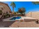 Backyard pool with clear blue water, framed by decorative concrete and a desert-style landscape at 12622 W Apodaca Dr, Litchfield Park, AZ 85340