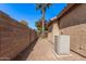 Enclosed side yard showing block wall, desert landscaping, and access to the backyard at 12622 W Apodaca Dr, Litchfield Park, AZ 85340