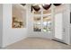 Bright dining area with tile flooring, large windows, and a view of the outdoor patio space at 16769 W Brookhaven Ct, Surprise, AZ 85387