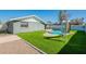 A relaxing backyard featuring a refreshing pool, artificial grass, and a slide at 1715 E El Parque Dr, Tempe, AZ 85282