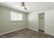 Bedroom with wood floors, ceiling fan, window, and closet at 1715 E El Parque Dr, Tempe, AZ 85282