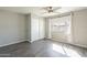 This bedroom is bright and airy with a sliding closet door, hardwood floors, and a ceiling fan at 1715 E El Parque Dr, Tempe, AZ 85282