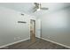 Bedroom with wood floors, ceiling fan, and doorway at 1715 E El Parque Dr, Tempe, AZ 85282