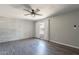 Bedroom featuring modern ceiling fan, painted brick wall and gray plank floors at 1715 E El Parque Dr, Tempe, AZ 85282