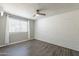 Bedroom with a painted brick wall, window, and wood flooring at 1715 E El Parque Dr, Tempe, AZ 85282