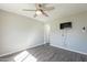 Bedroom showcasing hardwood floors, a ceiling fan, and a TV at 1715 E El Parque Dr, Tempe, AZ 85282